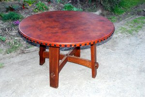 Accurate replica Gustav Stickley splay leg table with leather top.